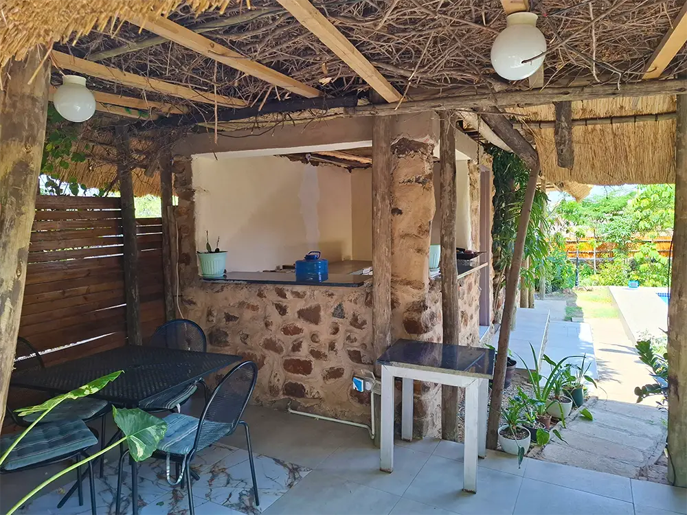 Covered outdoor patio with a kitchen counter
