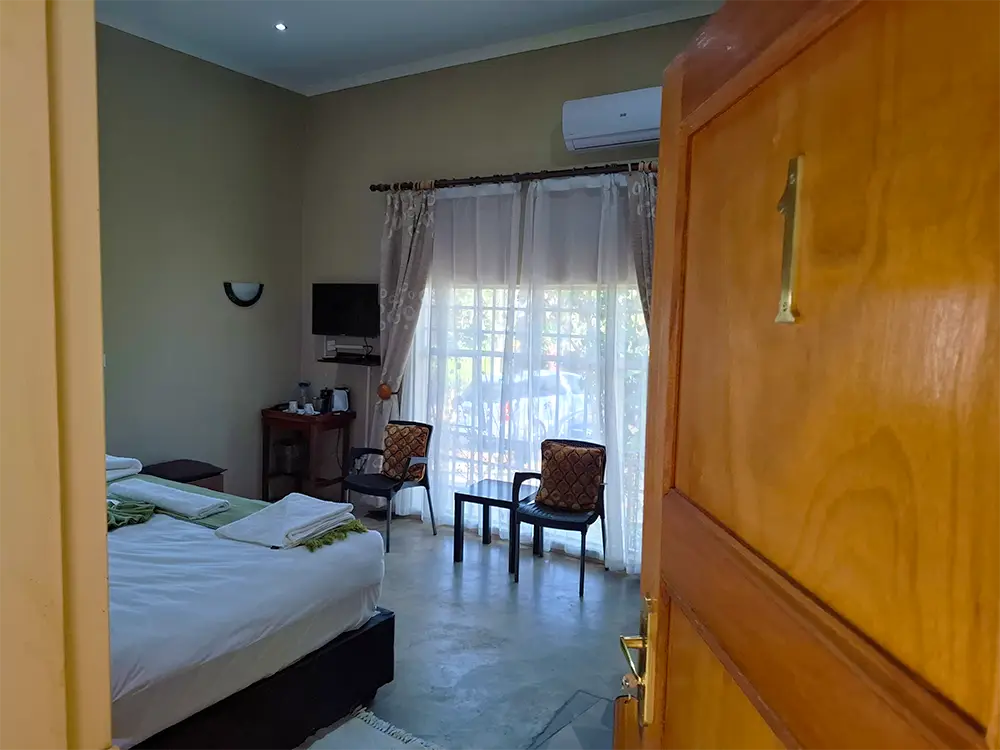 View into room 1 with a double bed and seating