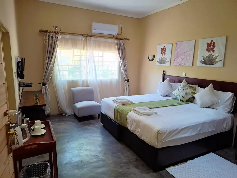 Guest room with a double bed and floral artwork